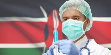 Mann mit Maske und Impfung vor Kenia Flagge