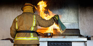 Feuerwehrmann löscht Küchenbrand