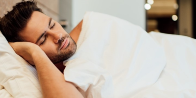 selective focus of handsome bearded man sleeping in bed