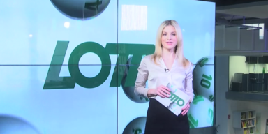 oe24.TV Moderatorin Denise Aichelburg vor Lotto-Hintergrund